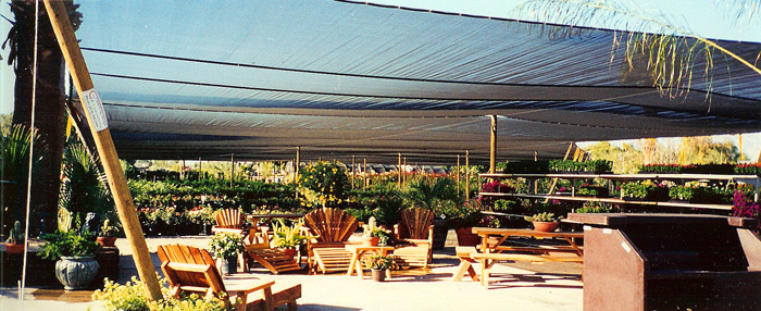 Retail Nursery Shade with wooden poles.